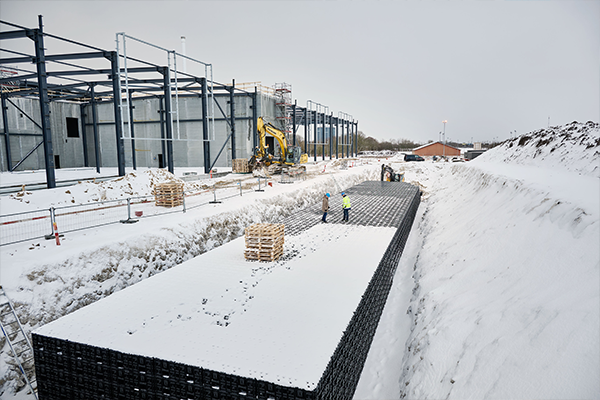 A construction site with snow AI-generated content may be incorrect.